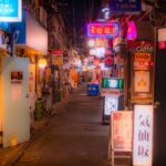 Narrow neon-lit alleyway at night in Shinjuku Tokyo