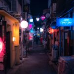 Narrow neon-lit alley at night in Shinjuku Golden Gai, Tokyo