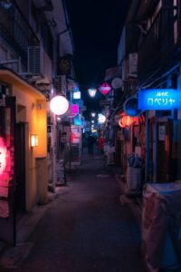 Narrow neon-lit alley at night in Shinjuku Golden Gai, Tokyo