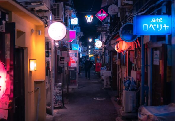 Narrow neon-lit alley at night in Shinjuku Golden Gai, Tokyo