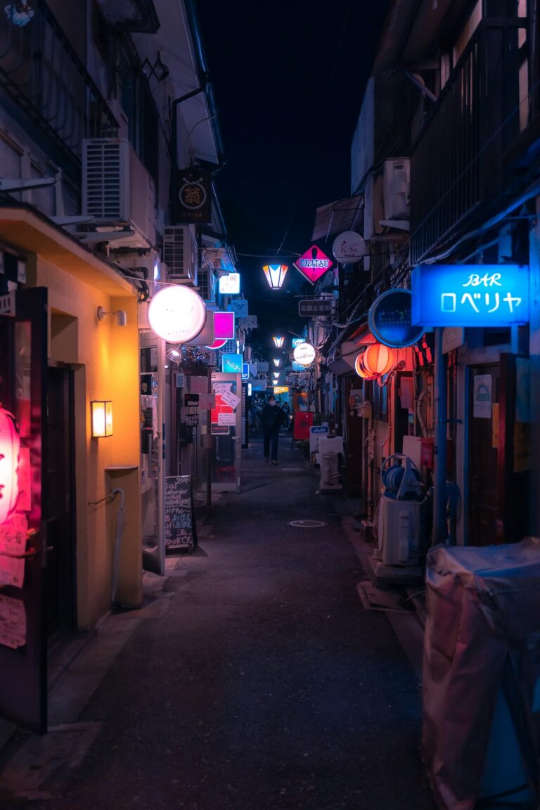 Narrow neon-lit alley at night in Shinjuku Golden Gai, Tokyo