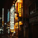 Neon signs illuminate a Shinjuku street in Tokyo at night