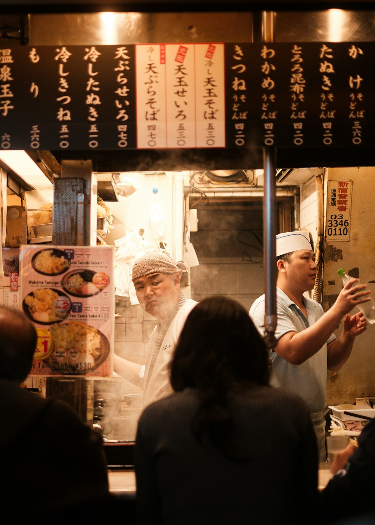A tiny Shinjuku counter shop with chef and customers in Omoide Yokocho