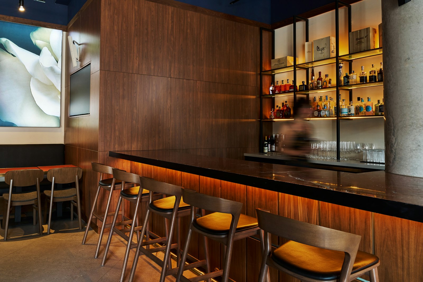 Interior of a small Japanese counter bar with bottles and glasses, the standard layout of a Kabukicho girls bar