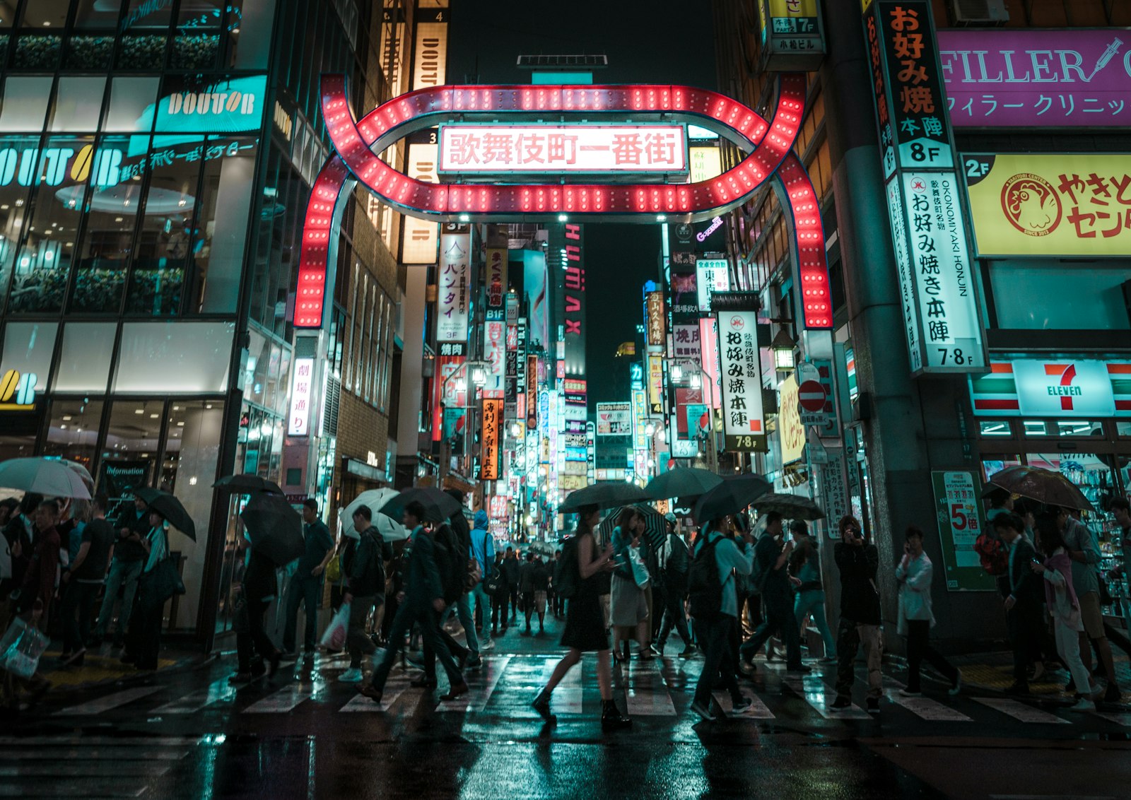 A busy Kabukicho street at night in Shinjuku, Tokyo, where street touts commonly approach foreign visitors outside nightlife venues