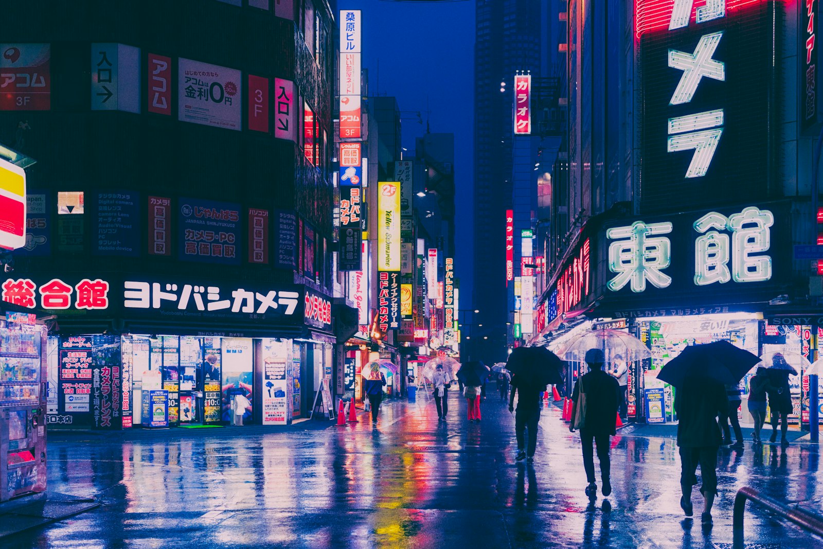People walking a Kabukicho side street at night in Shinjuku, Tokyo, near the district's host club area