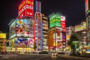 Neon signs of hostess clubs and bars lining a Kabukicho street in Shinjuku, Tokyo at night