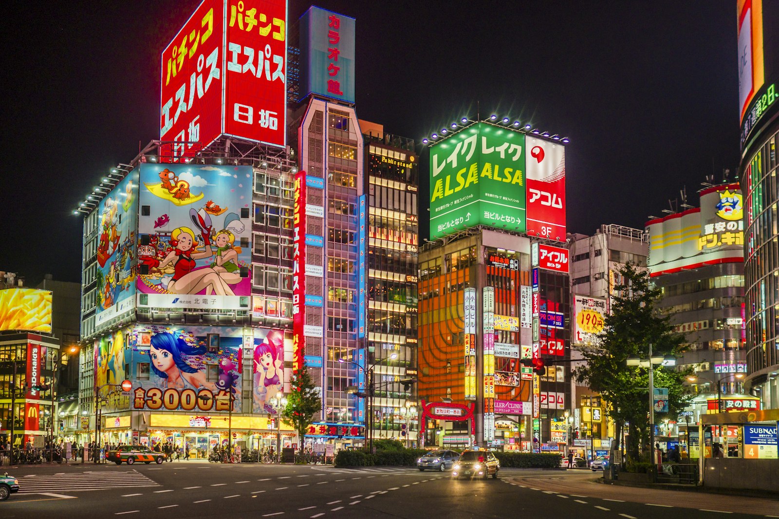 Neon signs of hostess clubs and bars lining a Kabukicho street in Shinjuku, Tokyo at night