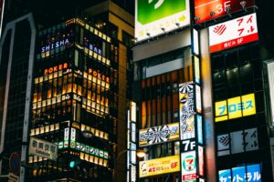 Neon signs stacked along a Kabukicho street in Shinjuku, Tokyo, the district with the highest concentration of hostess clubs