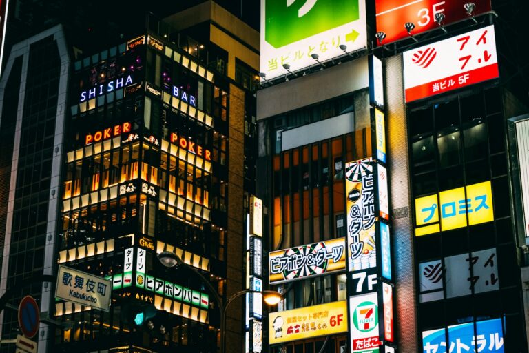 Neon signs stacked along a Kabukicho street in Shinjuku, Tokyo, the district with the highest concentration of hostess clubs