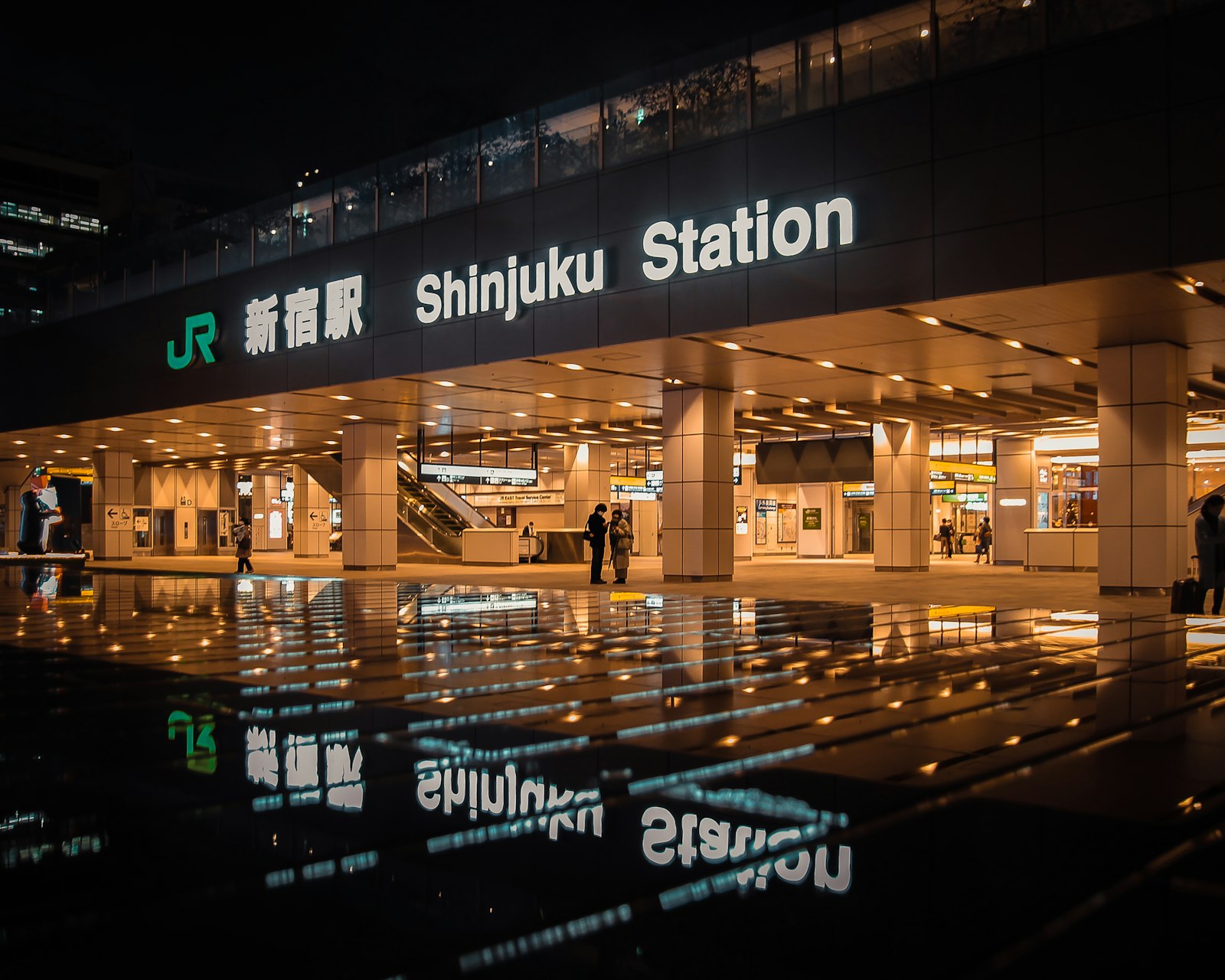 Brightly lit Shinjuku street at night near a police box, a safe place to go if approached by touts in Kabukicho