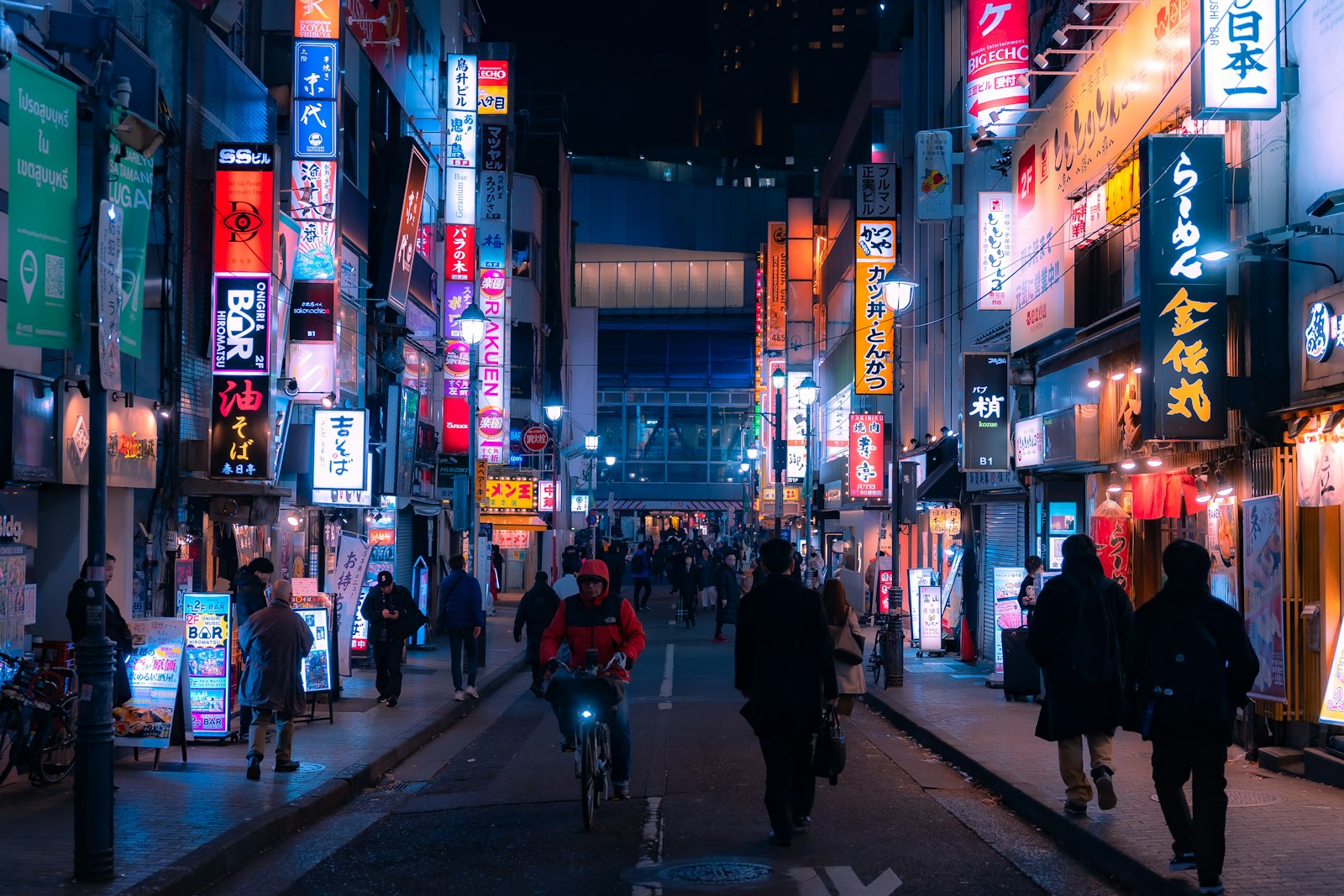 Narrow neon-lit alley in Shinjuku, where checking posted prices before entering avoids Kabukicho scams