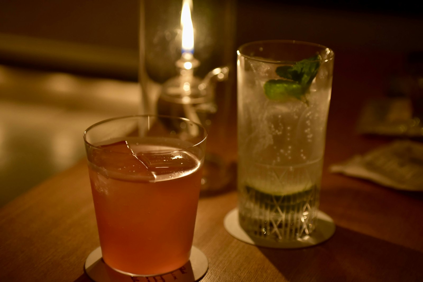 Whisky glasses and an ice bucket on a dimly lit table, typical of a Japanese hostess club set