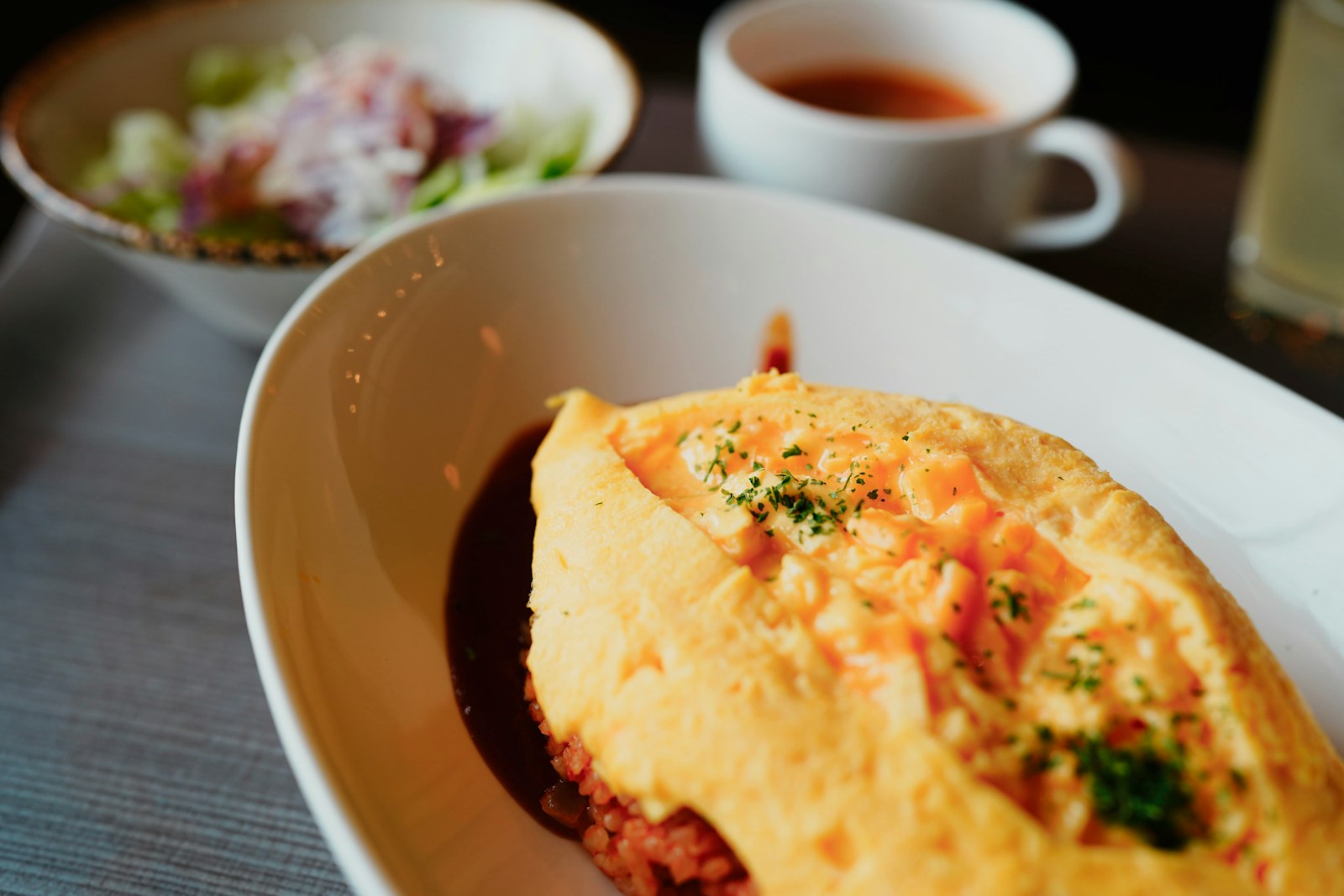 Omelette rice decorated with a ketchup drawing, a signature dish of the maid cafe experience in Tokyo