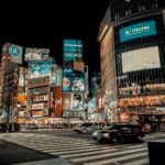 City lights spread to the horizon below a high-rise terrace, the classic Tokyo skyline seen after dark