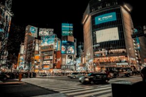 City lights spread to the horizon below a high-rise terrace, the classic Tokyo skyline seen after dark