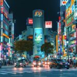 Crowds crossing Shibuya Scramble Crossing under neon signs at night, the starting point of Shibuya nightlife