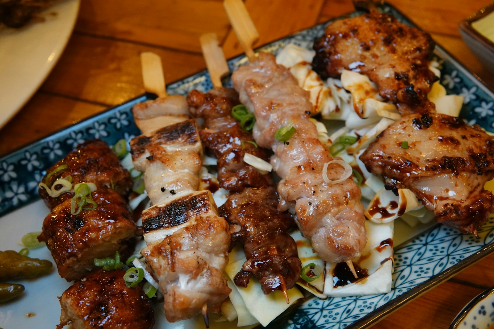 Charcoal-grilled yakitori skewers being prepared at a Japanese standing bar