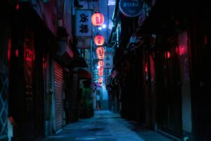 A narrow Tokyo alley lined with red lanterns and glowing standing bar doorways after dark