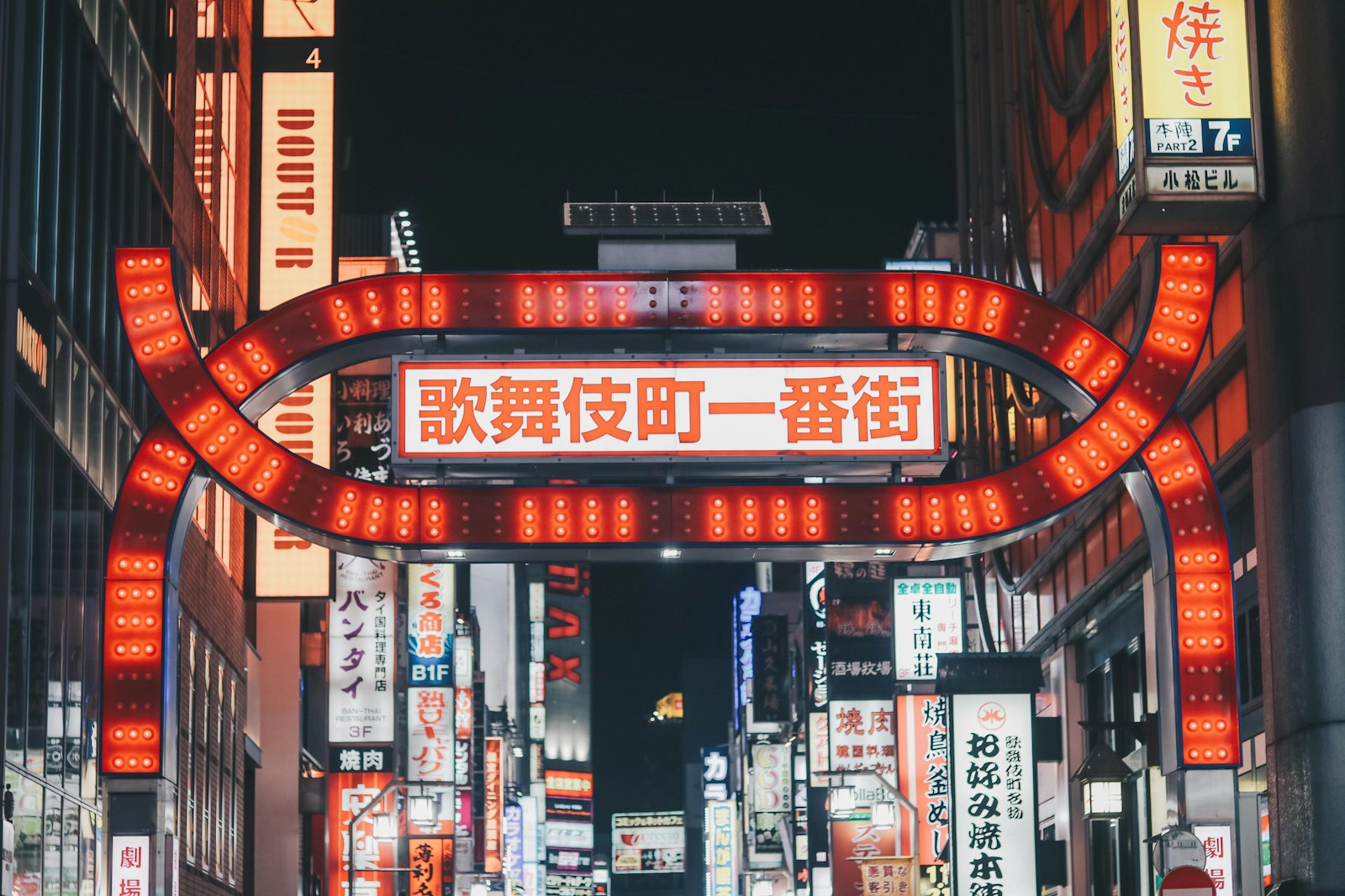 Neon-lit alley of tiny themed bars in Shinjuku Golden Gai, Tokyo