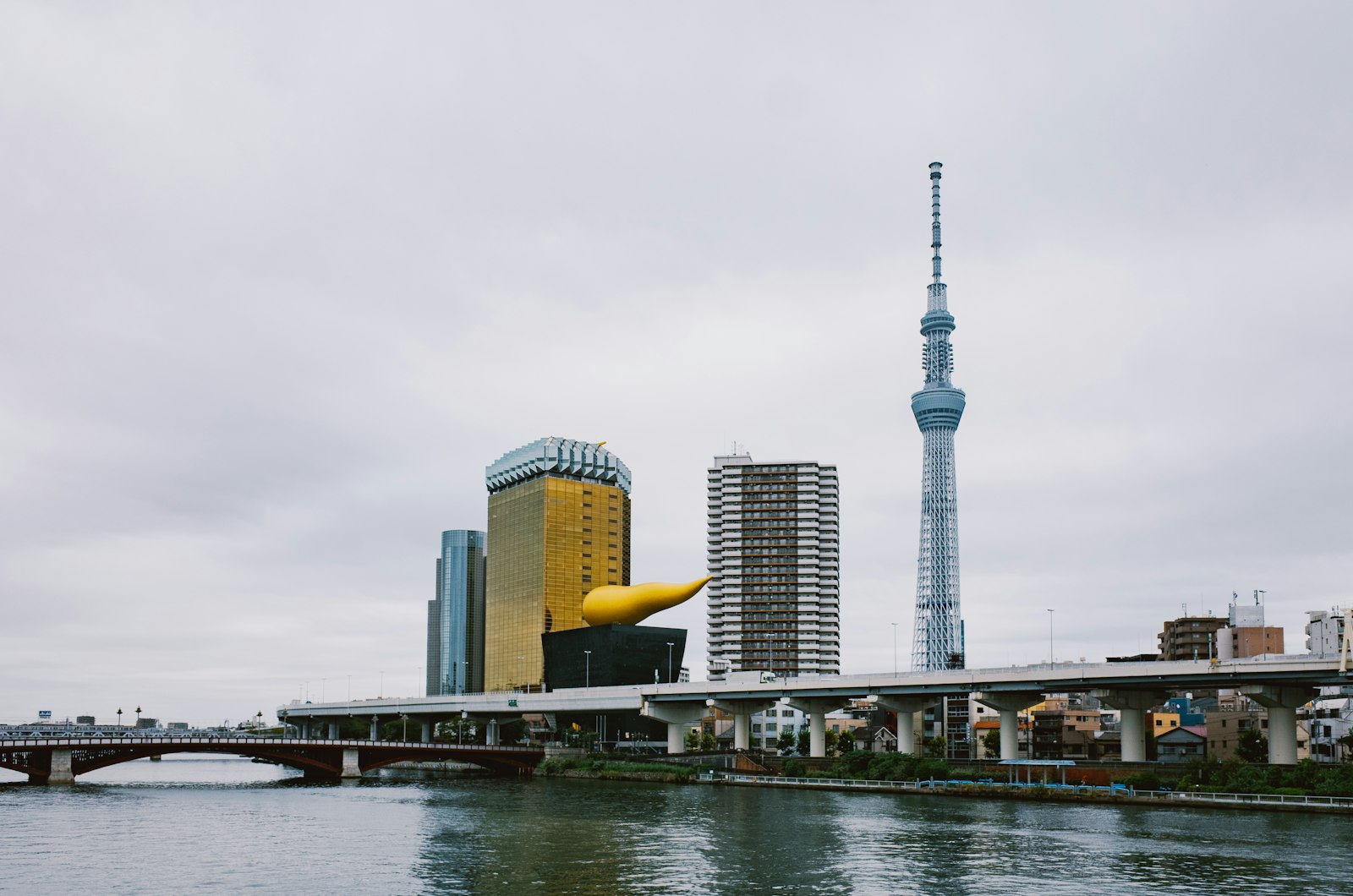 Tokyo Skytree lit up at night across the Sumida River from Asakusa, a popular stop after seeing the illuminated Senso-ji