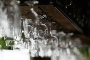 A row of craft beer taps on a bar counter at a Tokyo craft beer bar at night