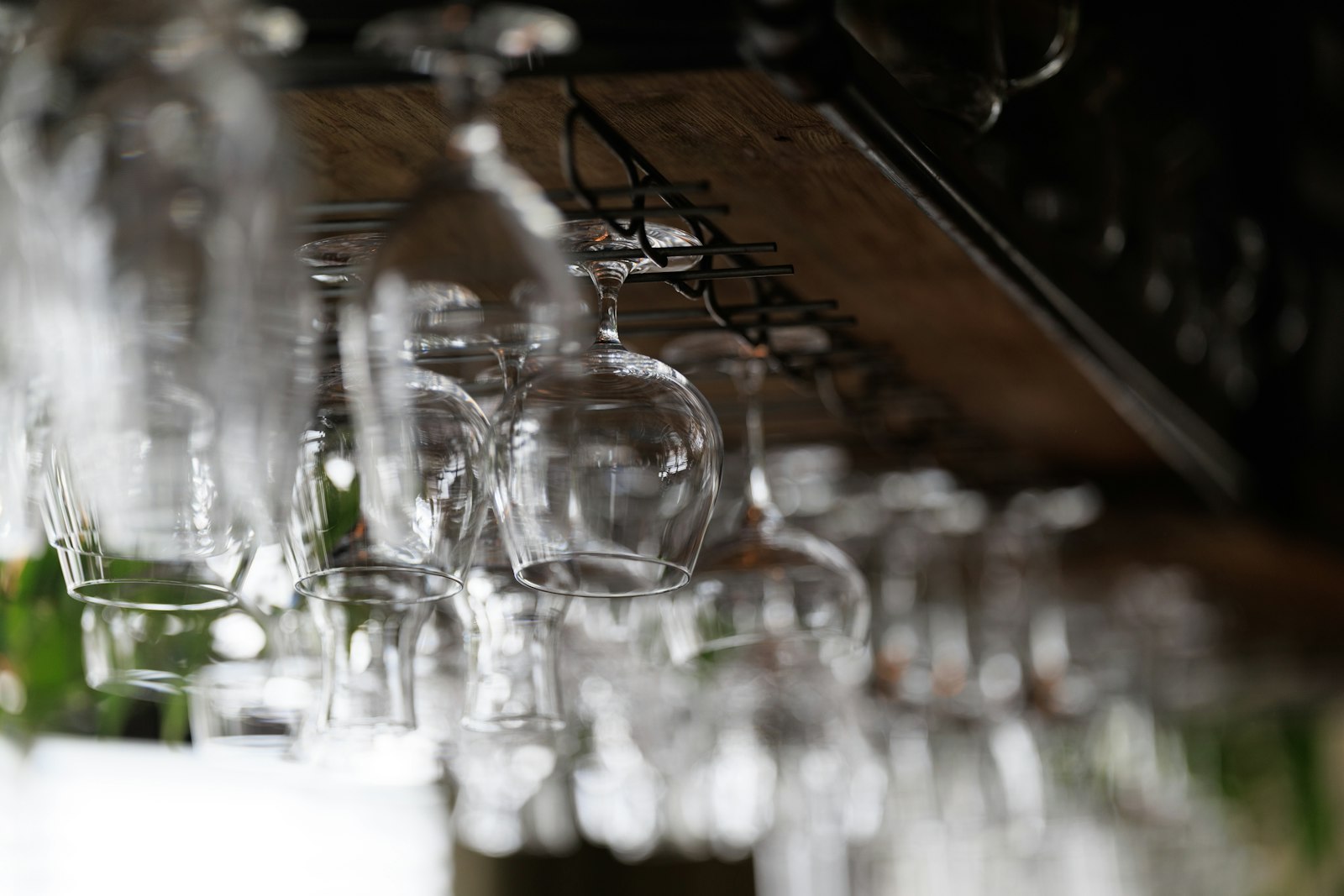 A row of craft beer taps on a bar counter at a Tokyo craft beer bar at night