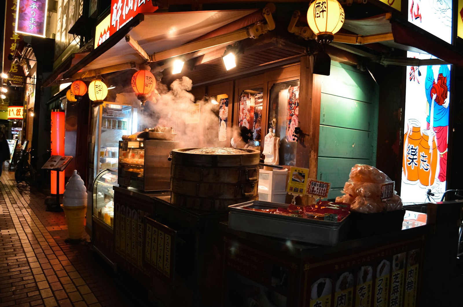 A Tokyo drinking street under the elevated railway tracks with izakaya lanterns glowing at night