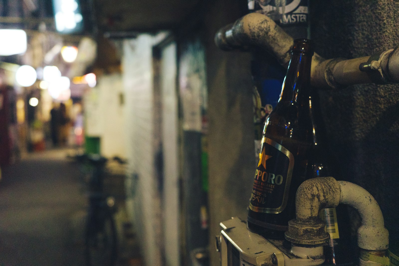 Narrow Golden Gai alley in Shinjuku lined with tiny bars and lanterns