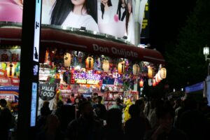 The glowing neon entrance of a Don Quijote discount store in Tokyo late at night