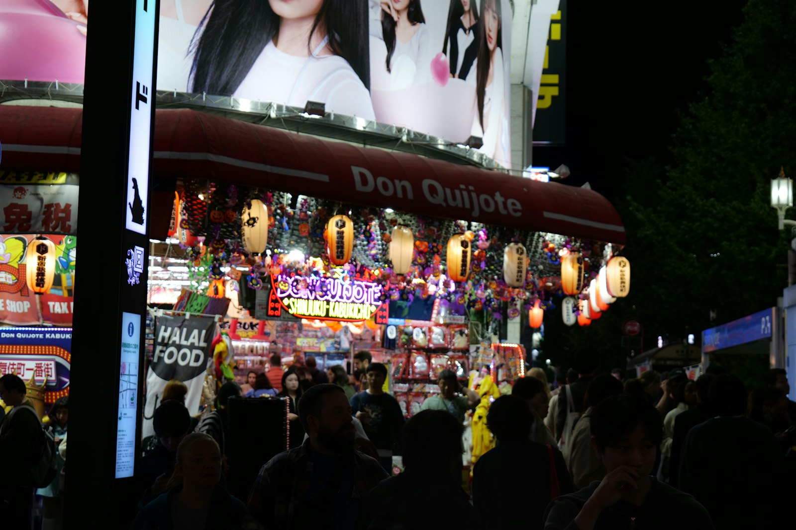 The glowing neon entrance of a Don Quijote discount store in Tokyo late at night