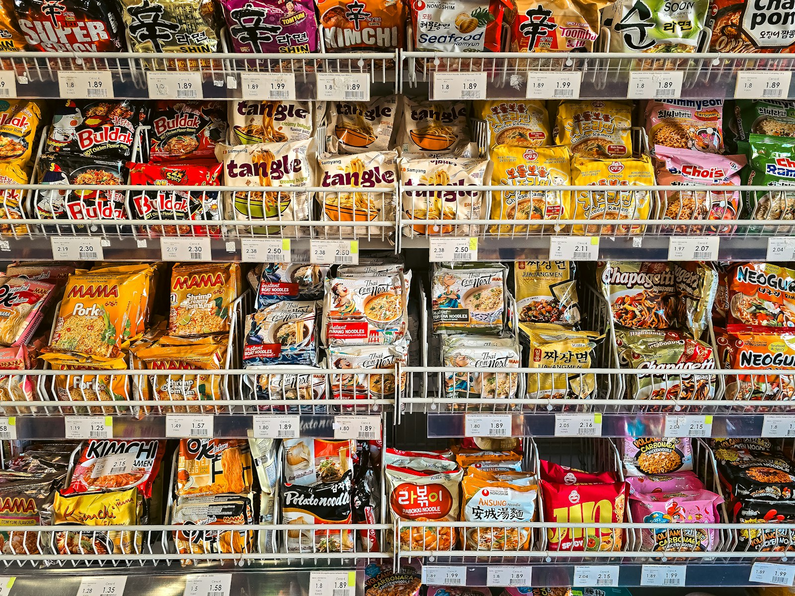 Crowded shelves of colorful Japanese snacks inside a Tokyo discount store