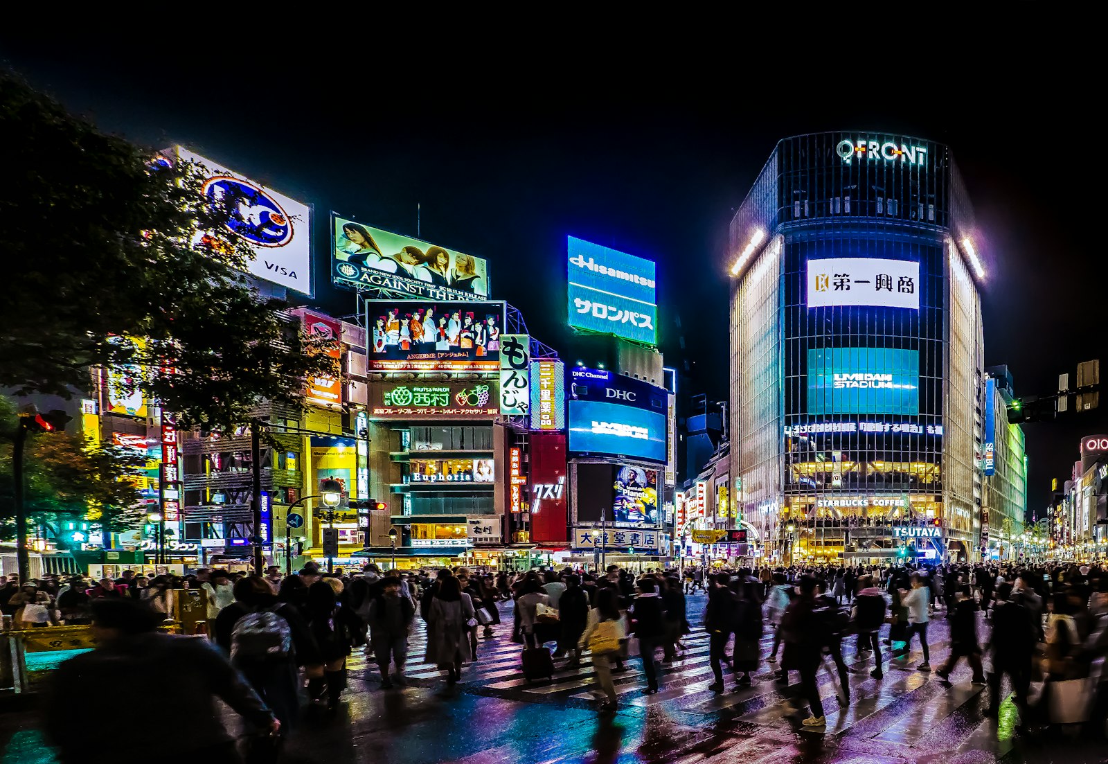 Stacked illuminated signboards on a Dogenzaka building, where most Shibuya counter bars are found above street level