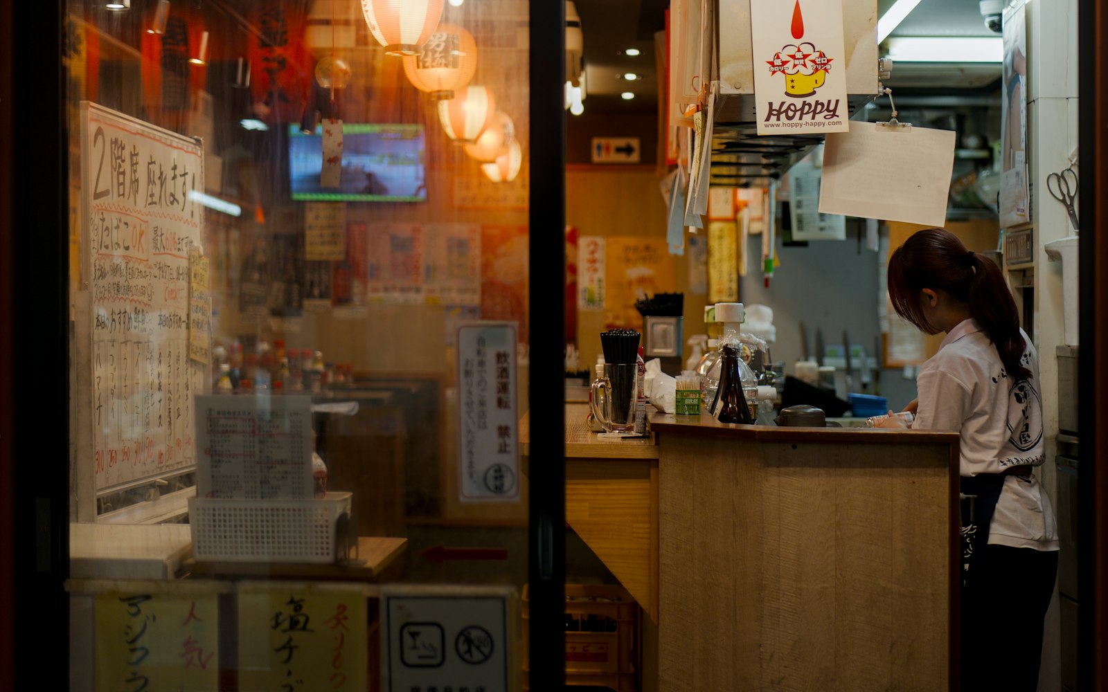 Draft beer and small izakaya dishes on a counter during a Tokyo bar crawl