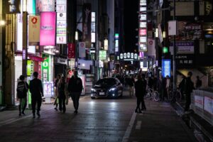 Crowded neon-lit street in Kabukicho, Shinjuku, where most tourist scams begin