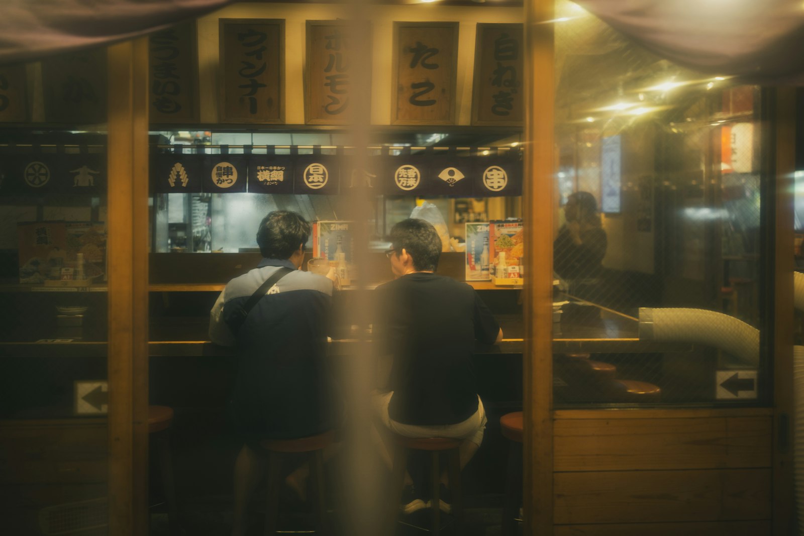 Counter seating inside a small Tokyo izakaya, the typical setting for a tourist's first night out