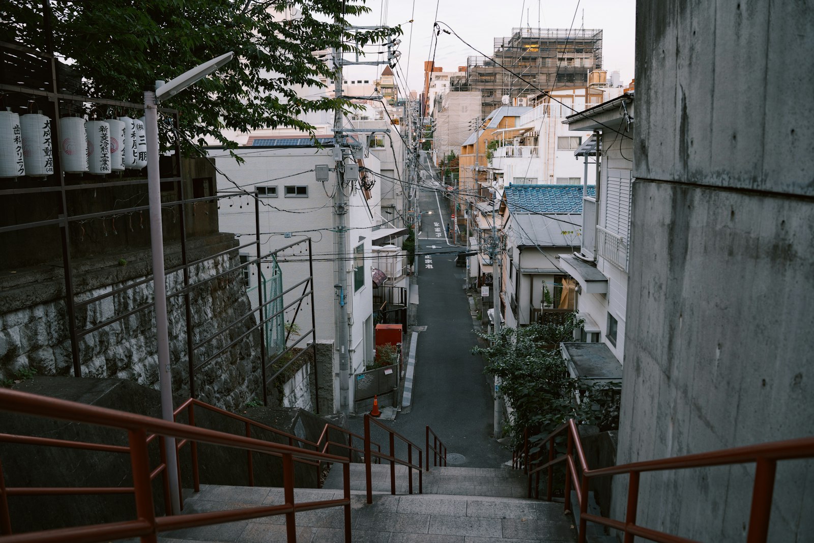 A quiet, well-lit residential street in Tokyo late at night