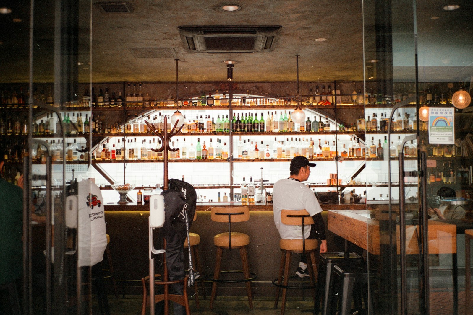 A bartender preparing a whisky highball at a quiet Tokyo bar counter