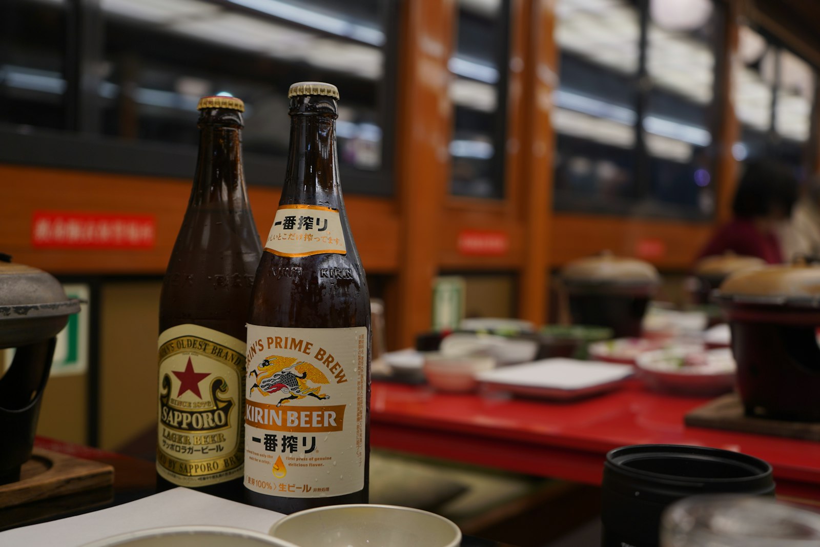 Rows of Japanese sake bottles on a shelf, a starting point for any sake beginner