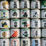 Rows of Japanese sake bottles lined up at a tasting counter, ready for a beginner's sake tasting in Tokyo