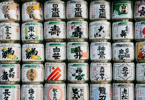 Rows of Japanese sake bottles lined up at a tasting counter, ready for a beginner's sake tasting in Tokyo
