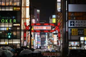 The illuminated Kabukicho gate in Shinjuku at night, where bottakuri touts often wait for tourists