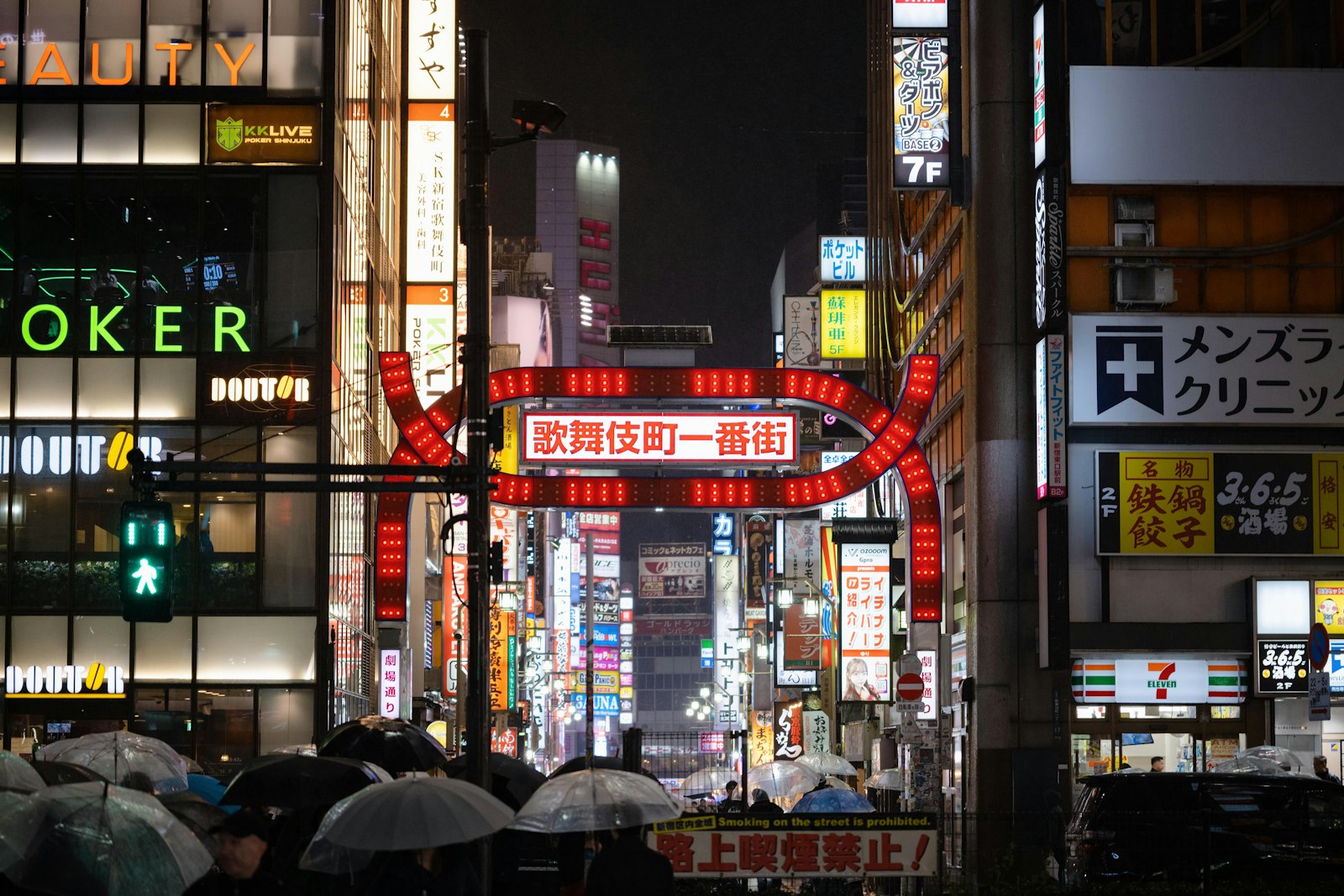 The illuminated Kabukicho gate in Shinjuku at night, where bottakuri touts often wait for tourists