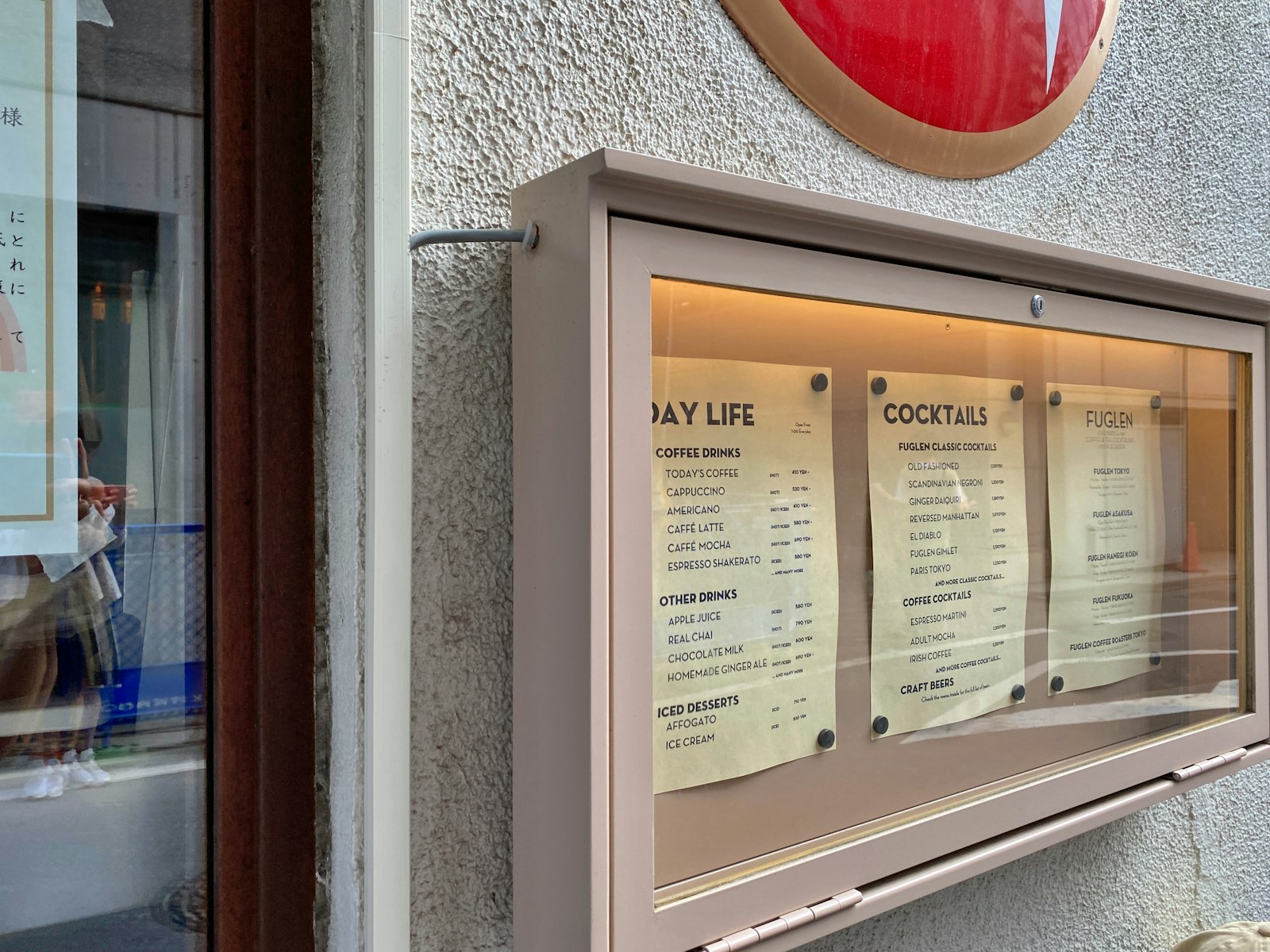 A clearly posted drink price list inside a Tokyo bar, the first thing to check before ordering