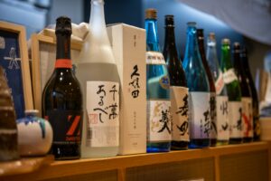 Shelves of sake bottles inside a Japanese liquor store, the setting for kakuuchi sake shop drinking in Tokyo