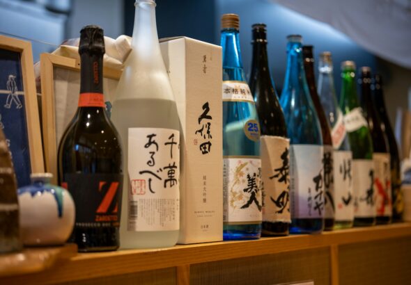 Shelves of sake bottles inside a Japanese liquor store, the setting for kakuuchi sake shop drinking in Tokyo