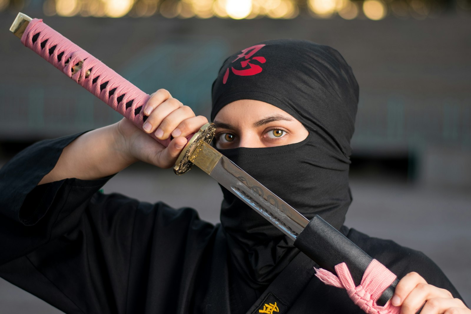 Person in a black ninja costume, the look you'll see at a ninja restaurant in Tokyo