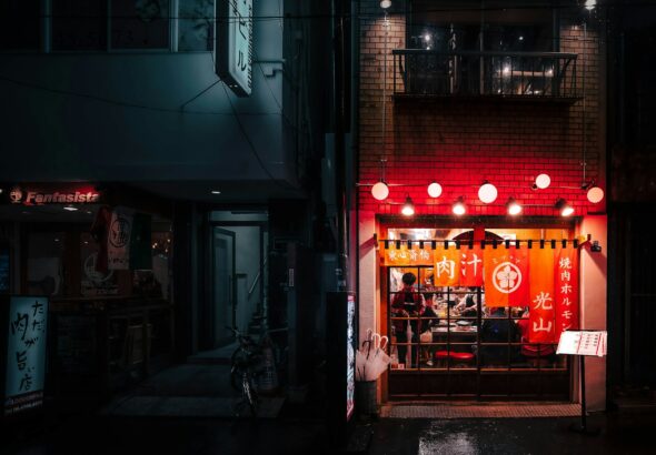 Office workers drinking at a lantern-lit izakaya, a typical scene of salaryman drinking culture in Tokyo