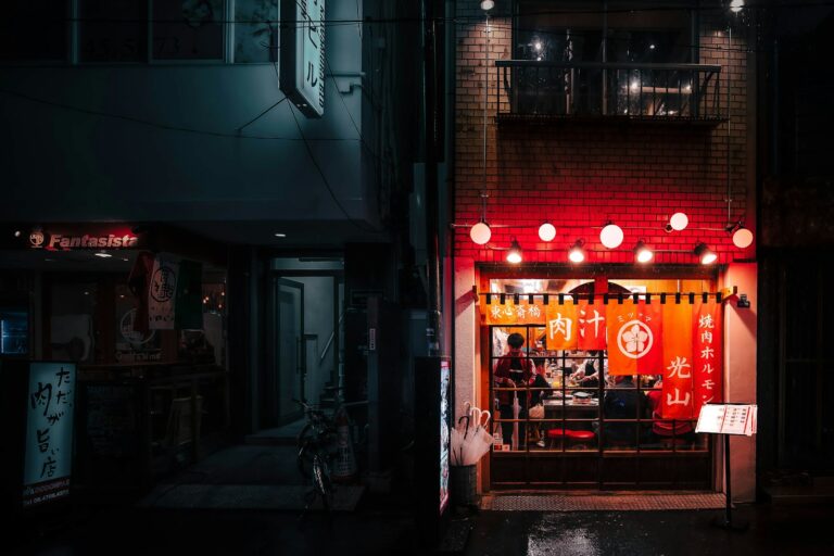 Office workers drinking at a lantern-lit izakaya, a typical scene of salaryman drinking culture in Tokyo