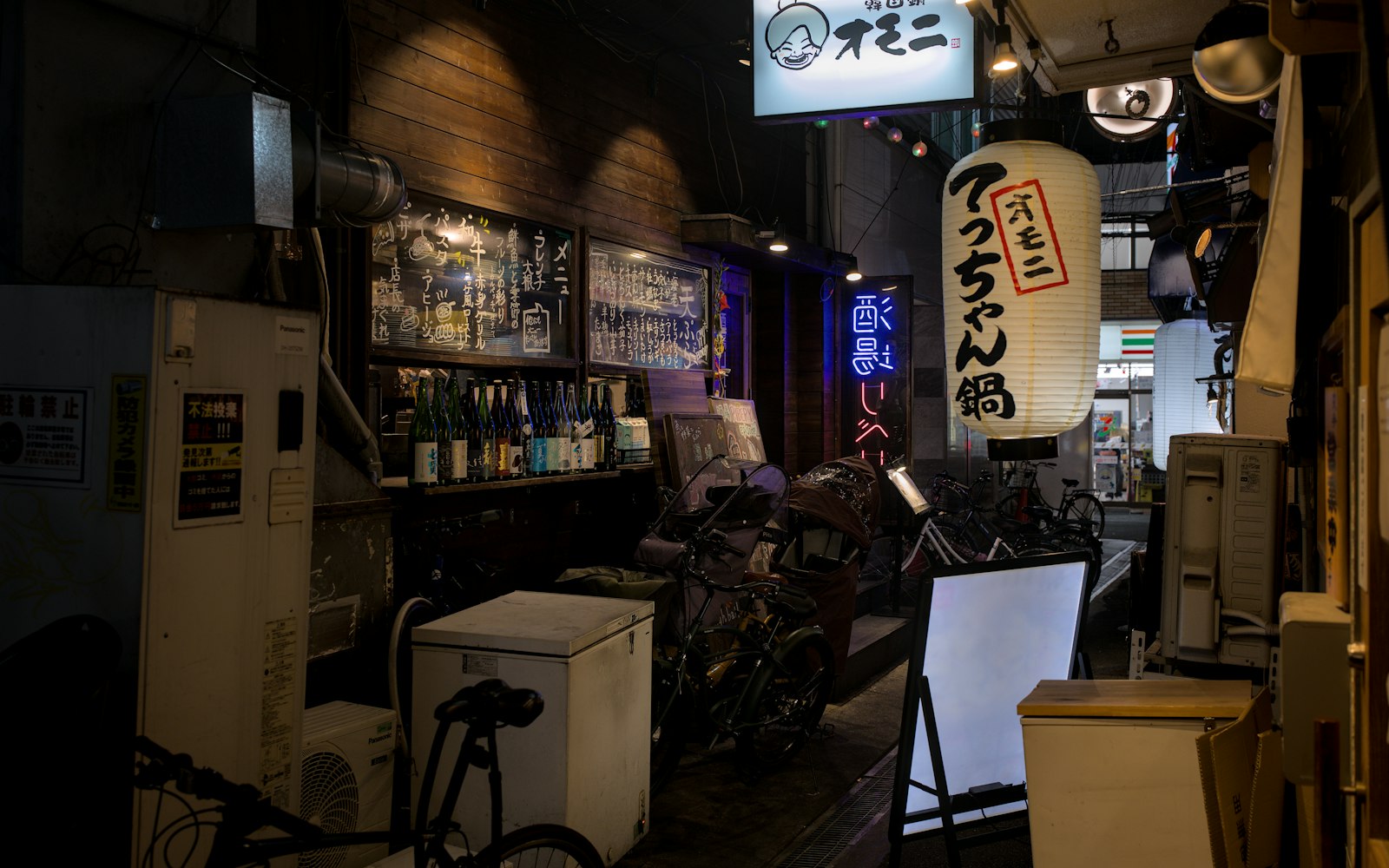 A karaoke microphone on a small bar counter — singing is the social centre of a Japanese snack bar